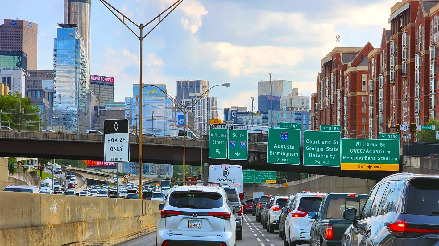 Atlanta I-75/I-85 Downtown Connector with HOV lane and signs for Mercedes-Benz Stadium and Georgia State University